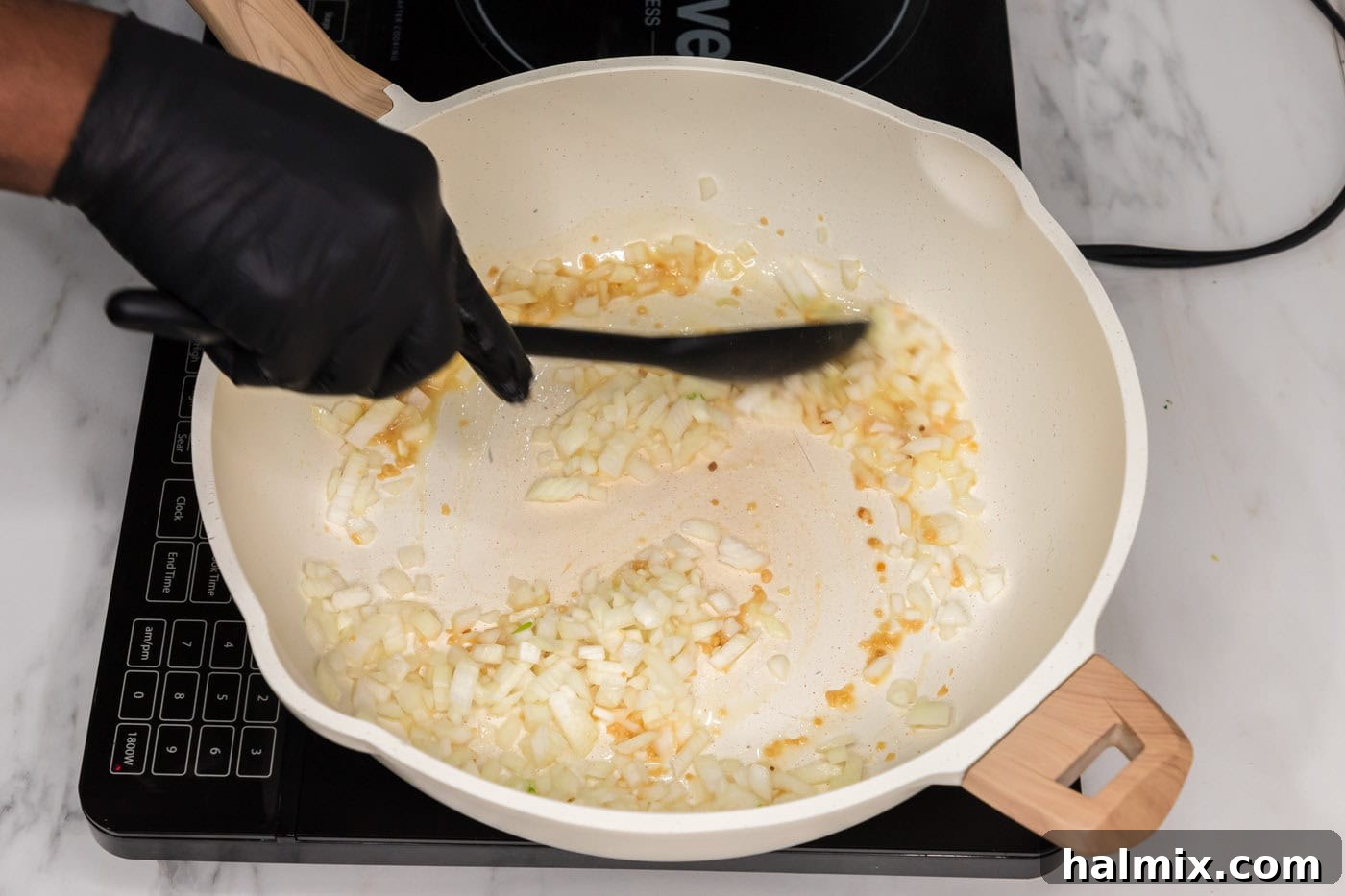 Sautéing garlic and onion in a hot skillet, releasing aromatic flavors