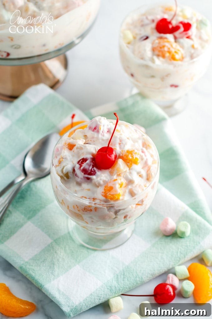 A beautifully arranged individual dessert dish filled with the classic Ambrosia Salad, garnished and ready to be enjoyed.