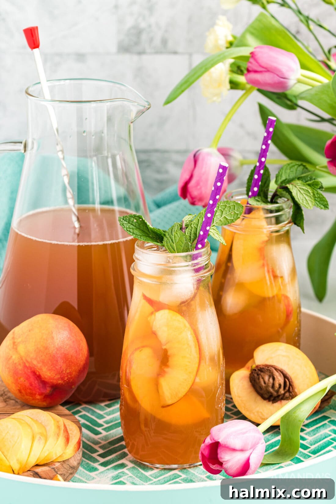 Sun-Kissed Peach Tea 3 Two bottles of homemade peach iced tea, ready for serving.