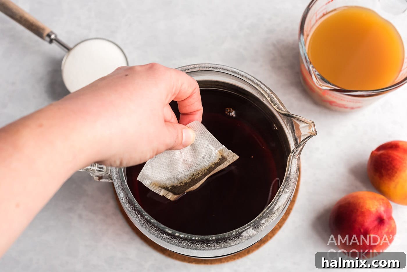 Sun-Kissed Peach Tea 5 Adding cold brew tea bags to a pitcher of water.