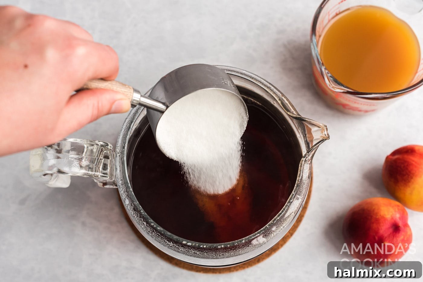 Sun-Kissed Peach Tea 6 Stirring granulated sugar into the cold brew tea.