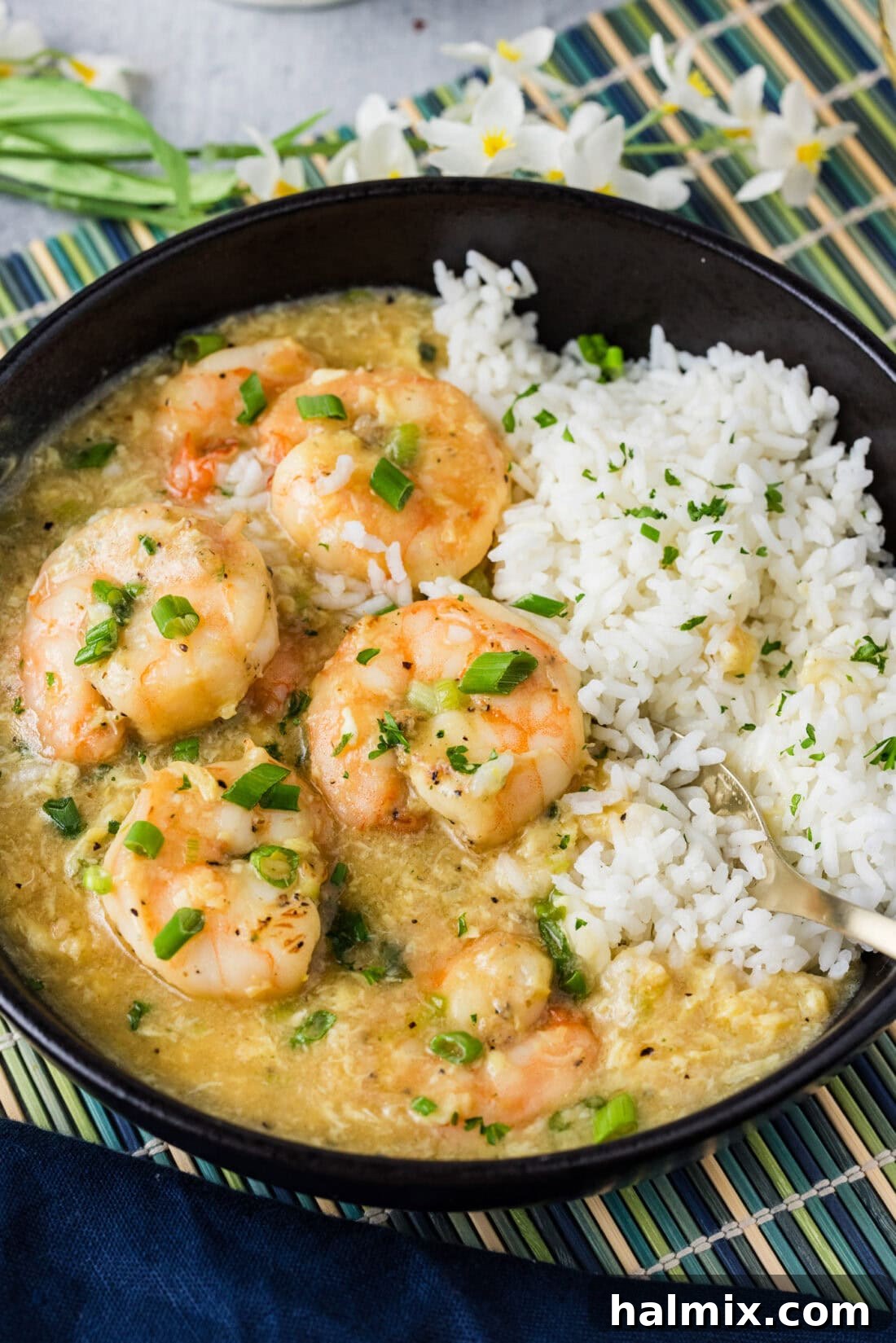 Close up photo of a bowl of rice and Shrimp with Lobster Sauce