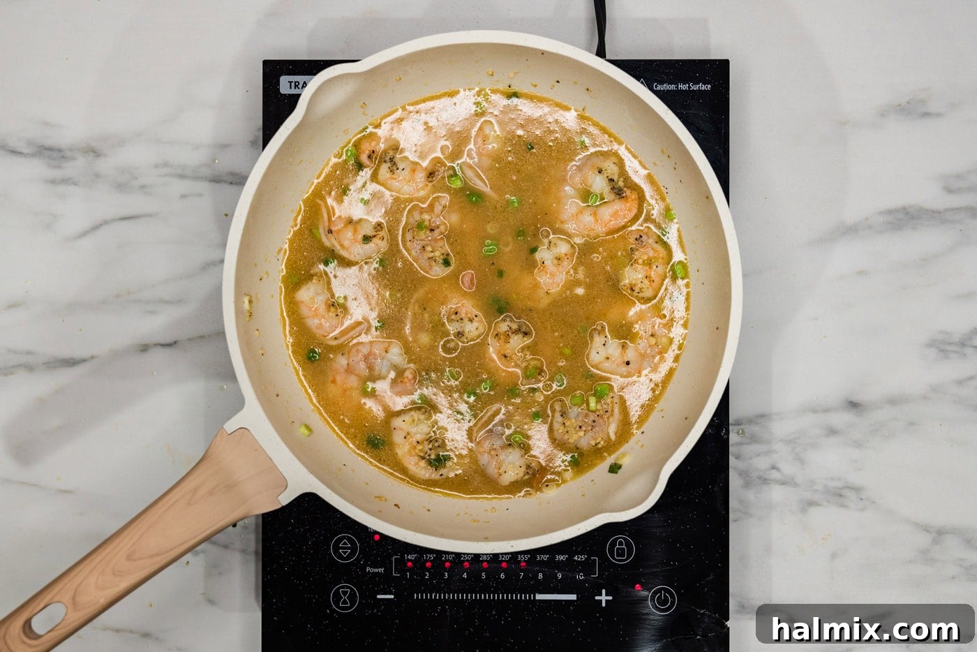 chicken base added to shrimp in a skillet