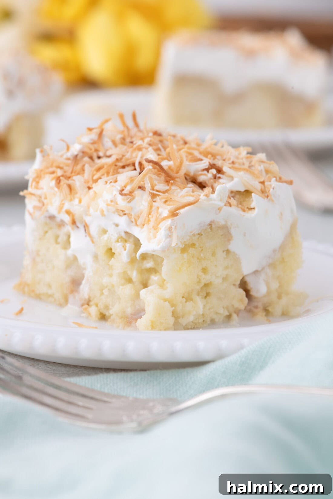 Slice of Coconut Poke Cake on a plate