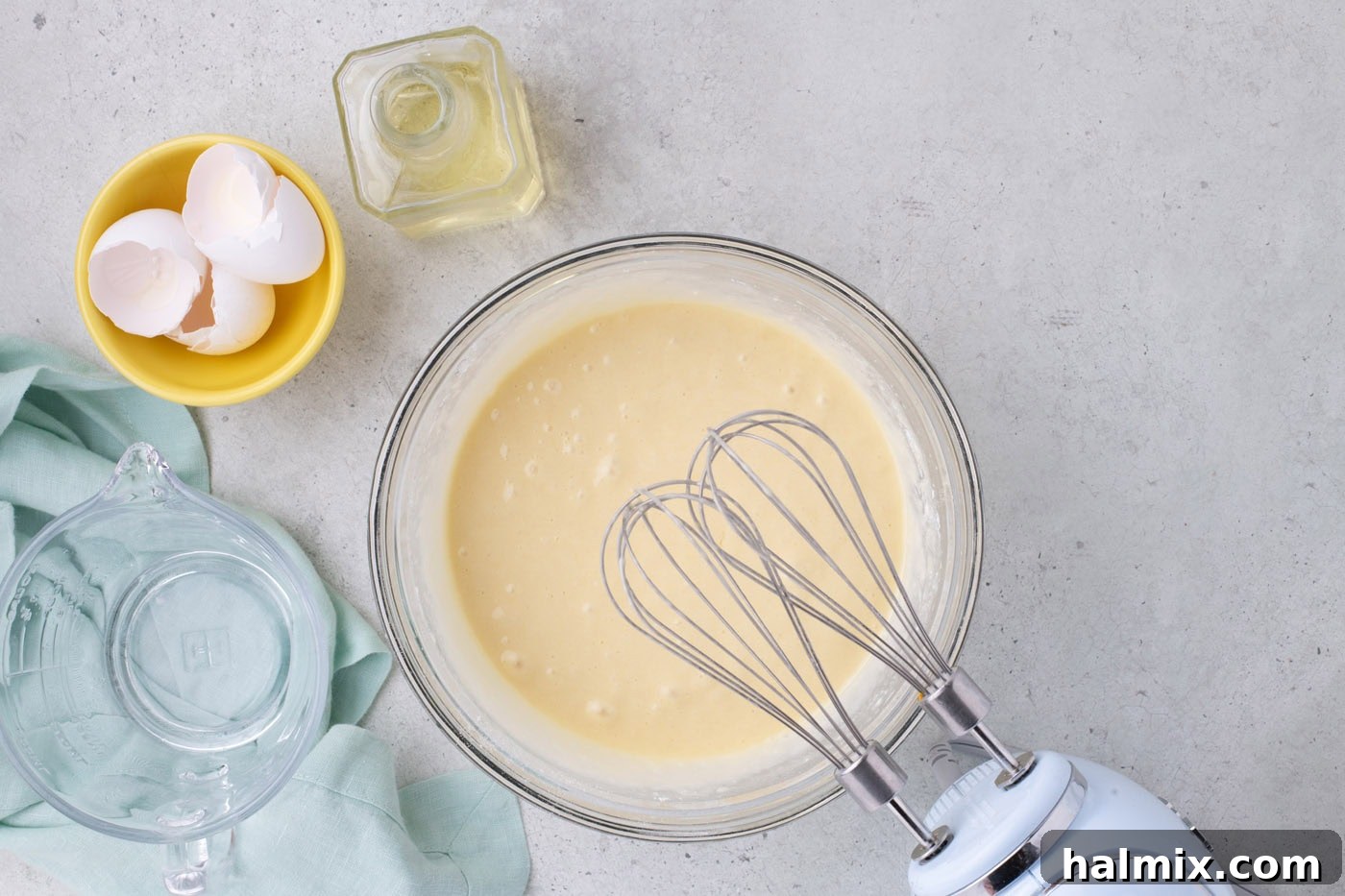 cake batter mixed in a bowl with a hand mixer