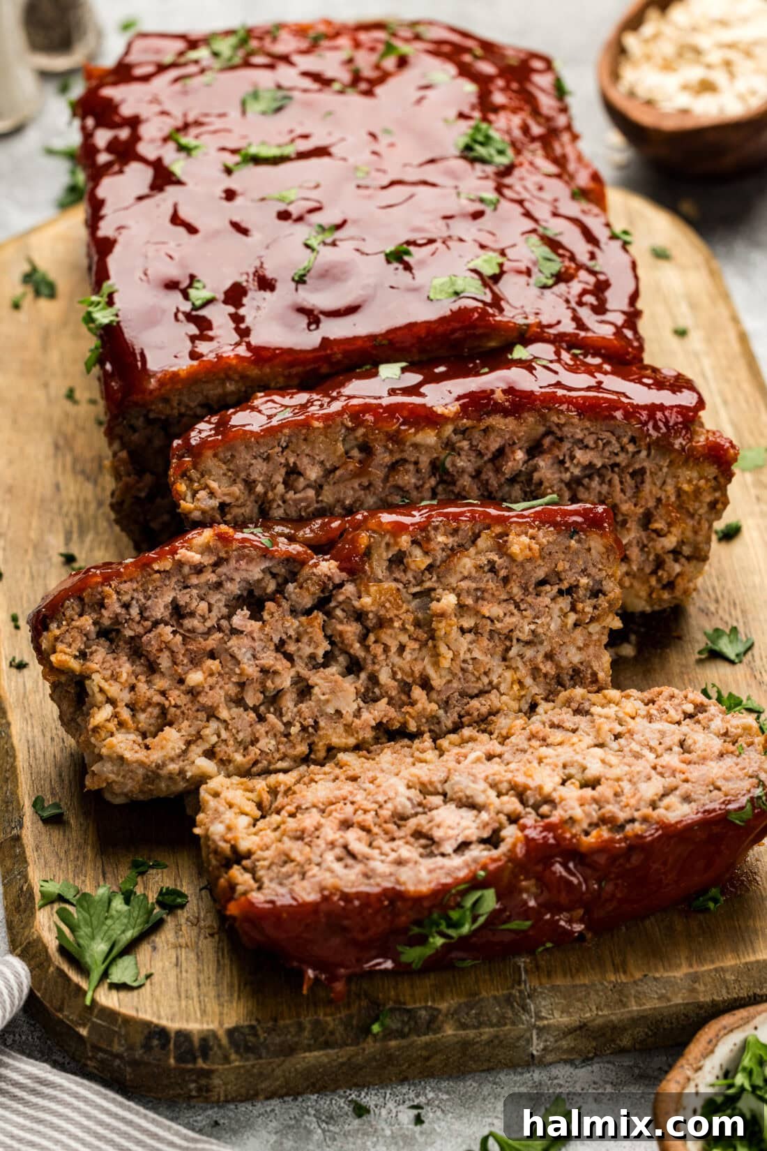 A close-up photograph of perfectly sliced Quaker Oats Meatloaf, highlighting its tender texture and delicious glaze.