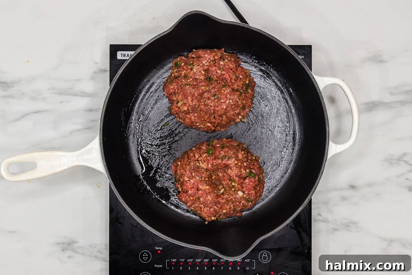 Fiesta Burger 8 Taco burger patties sizzling and cooking in a hot skillet, showing a beautiful sear on one side.