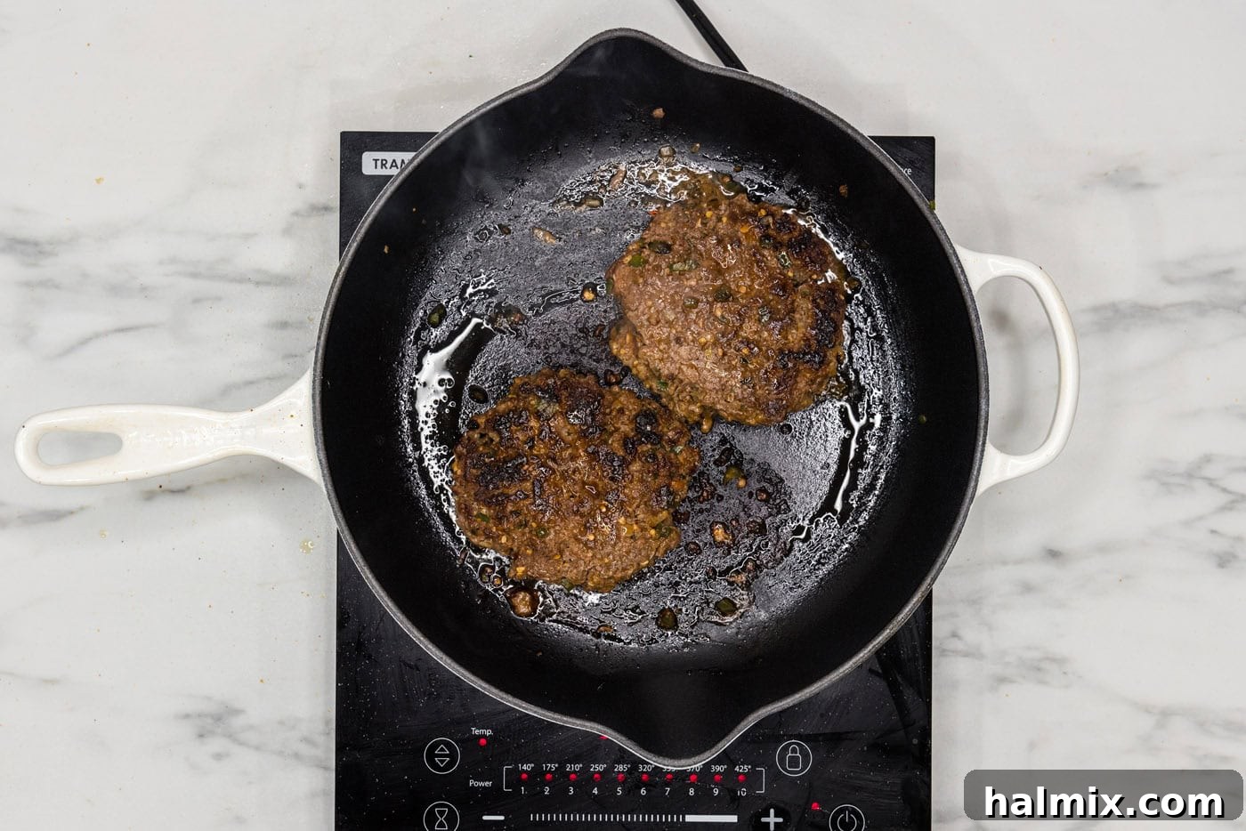 Fiesta Burger 9 Cooked taco burger patties resting in a skillet, displaying their perfectly seared exterior and juicy appearance.