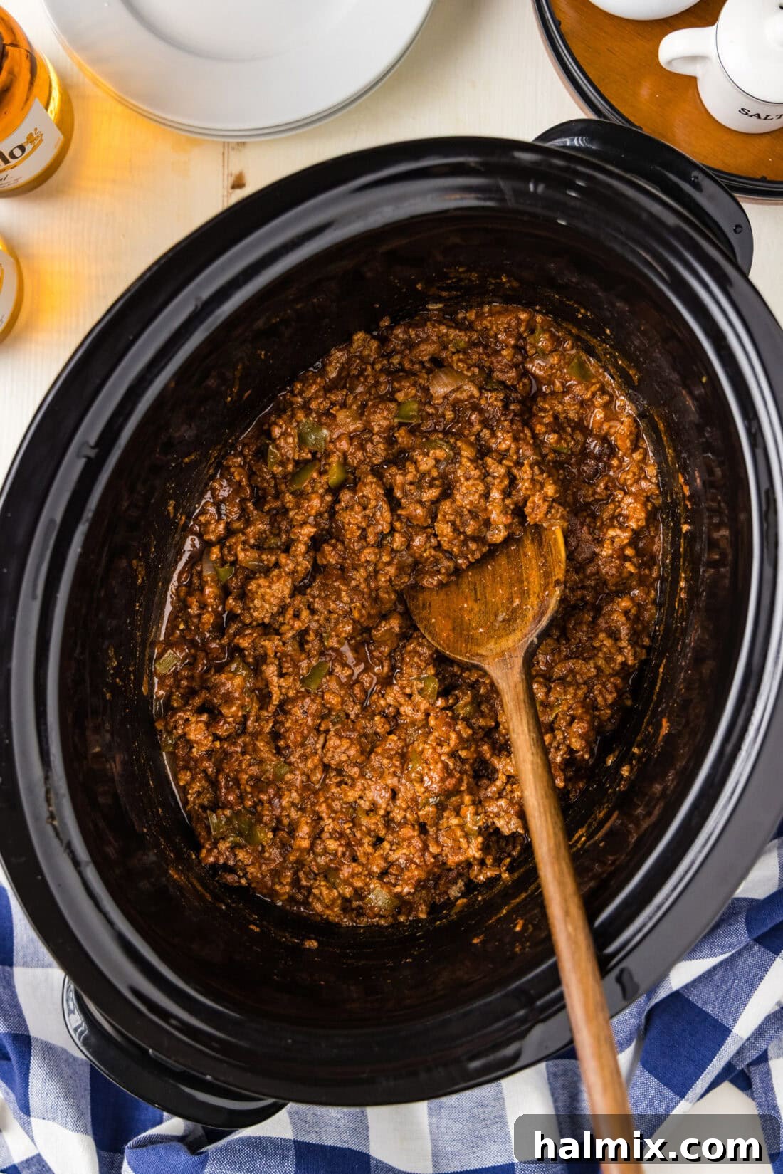 Ultimate Slow Cooker Sloppy Joes 2 Spoon in a Crockpot of Sloppy Joes, showcasing the rich, meaty sauce