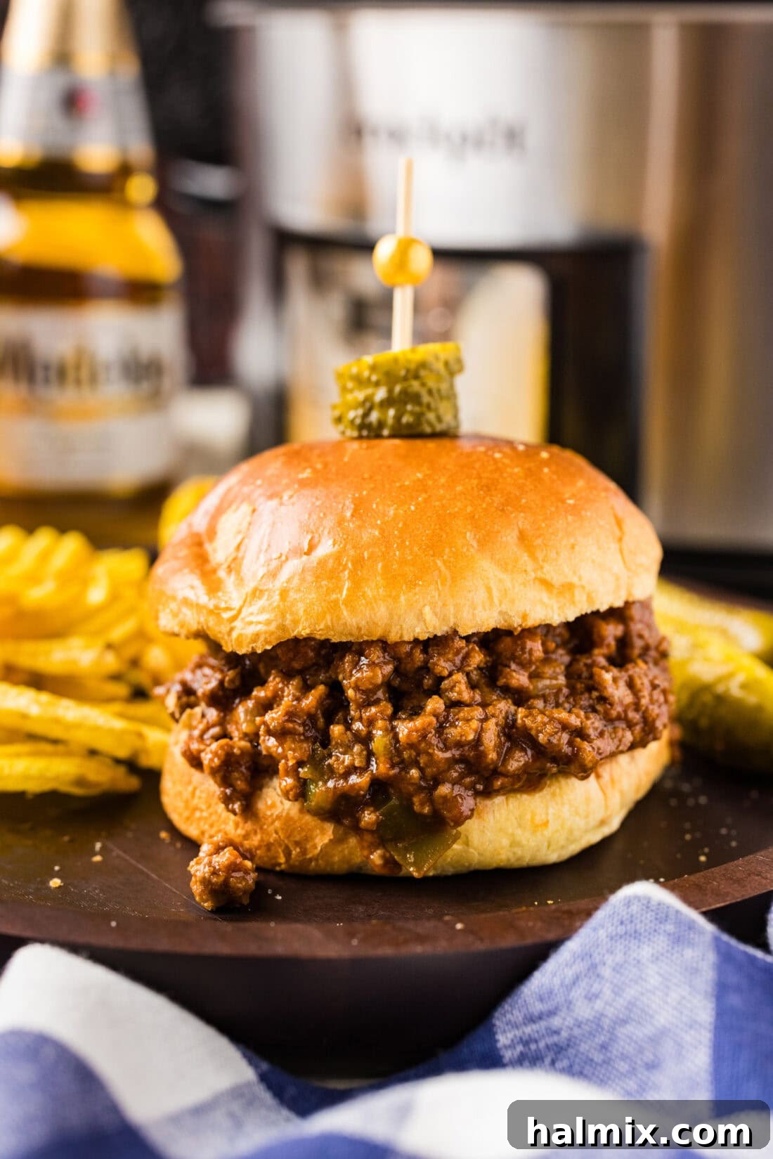 Ultimate Slow Cooker Sloppy Joes 3 A delicious crockpot sloppy joe sandwich served on a plate with potato chips