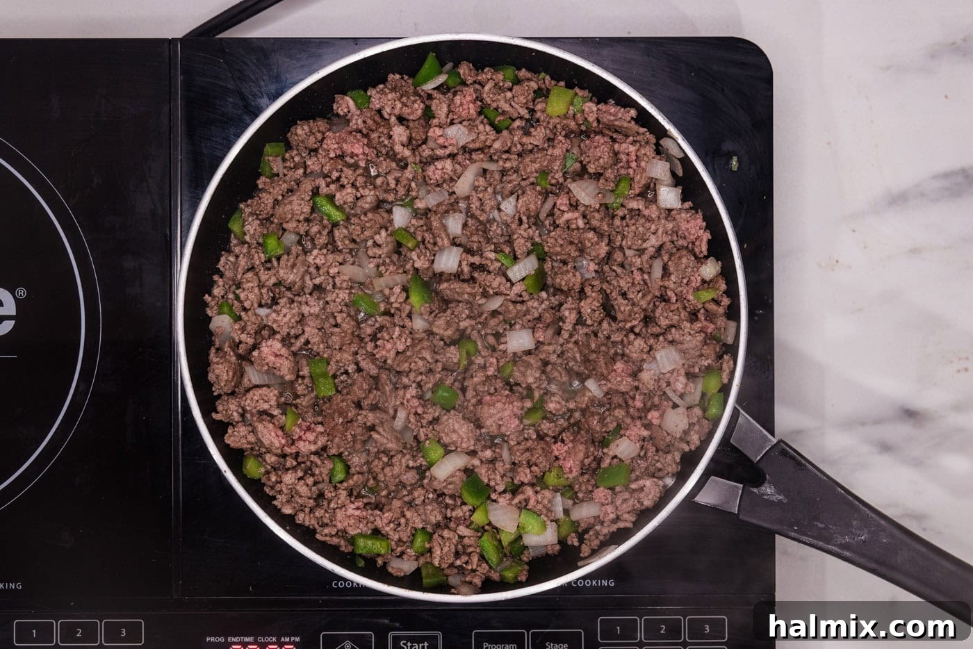 Ultimate Slow Cooker Sloppy Joes 5 browned ground beef with onion and bell pepper in a skillet, ready for the slow cooker