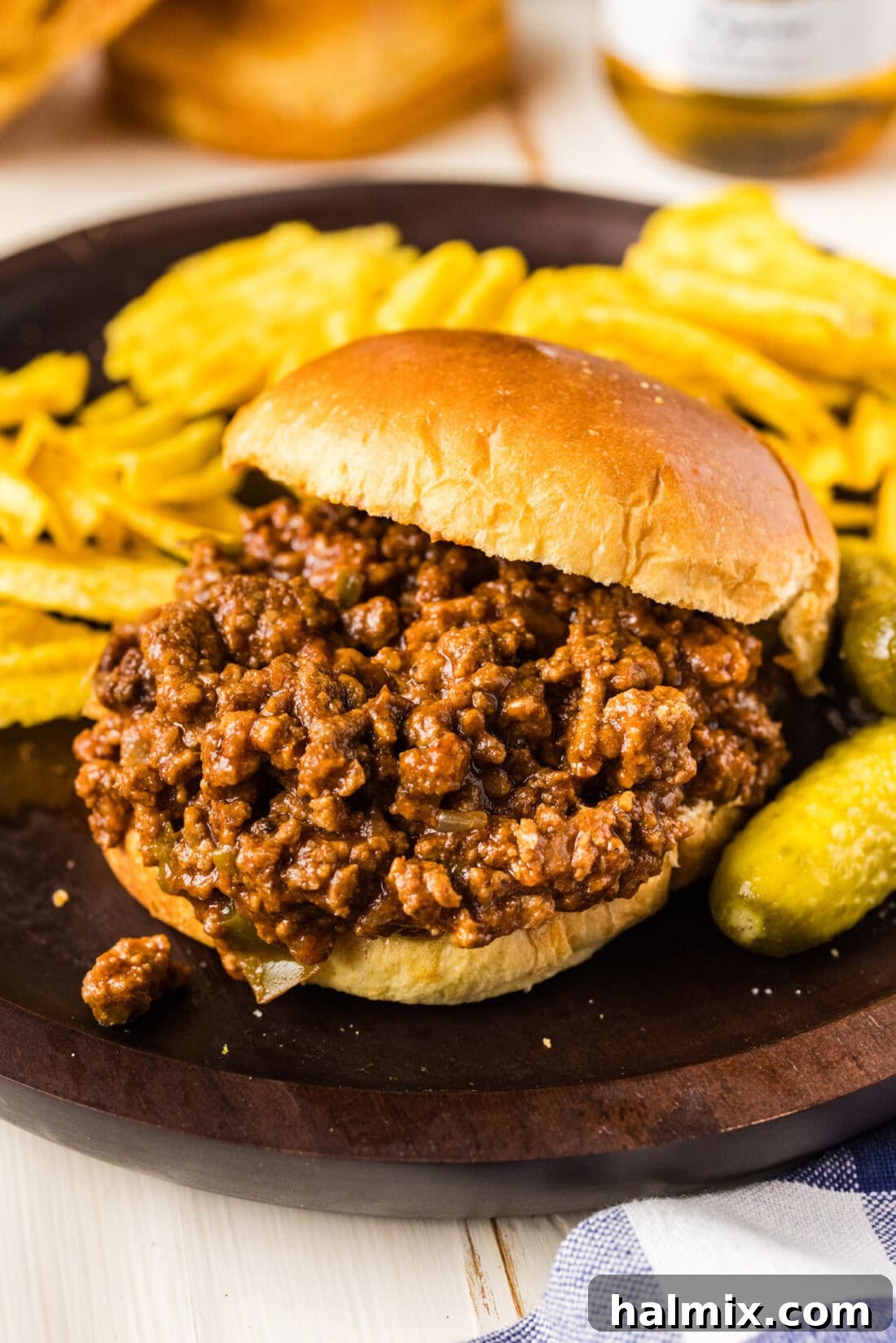 Ultimate Slow Cooker Sloppy Joes 8 Bun sliding off a Crockpot Sloppy Joe sandwich, showing the rich filling