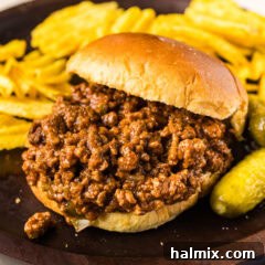 Ultimate Slow Cooker Sloppy Joes 9 Close up photo of a Crockpot Sloppy Joe sandwich, showing the hearty filling and bun