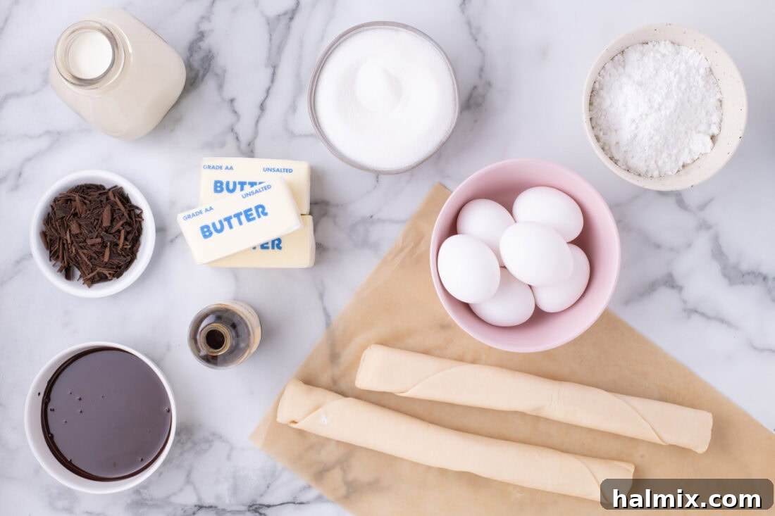 All the ingredients for French Silk Slab Pie laid out on a surface, including butter, chocolate, eggs, sugar, pie crusts, and whipping cream.