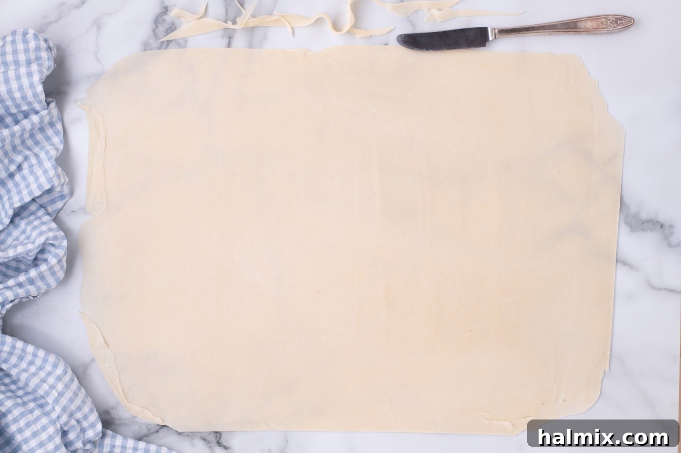 Pie crust formed into a rectangle, ready to be transferred to a baking pan.
