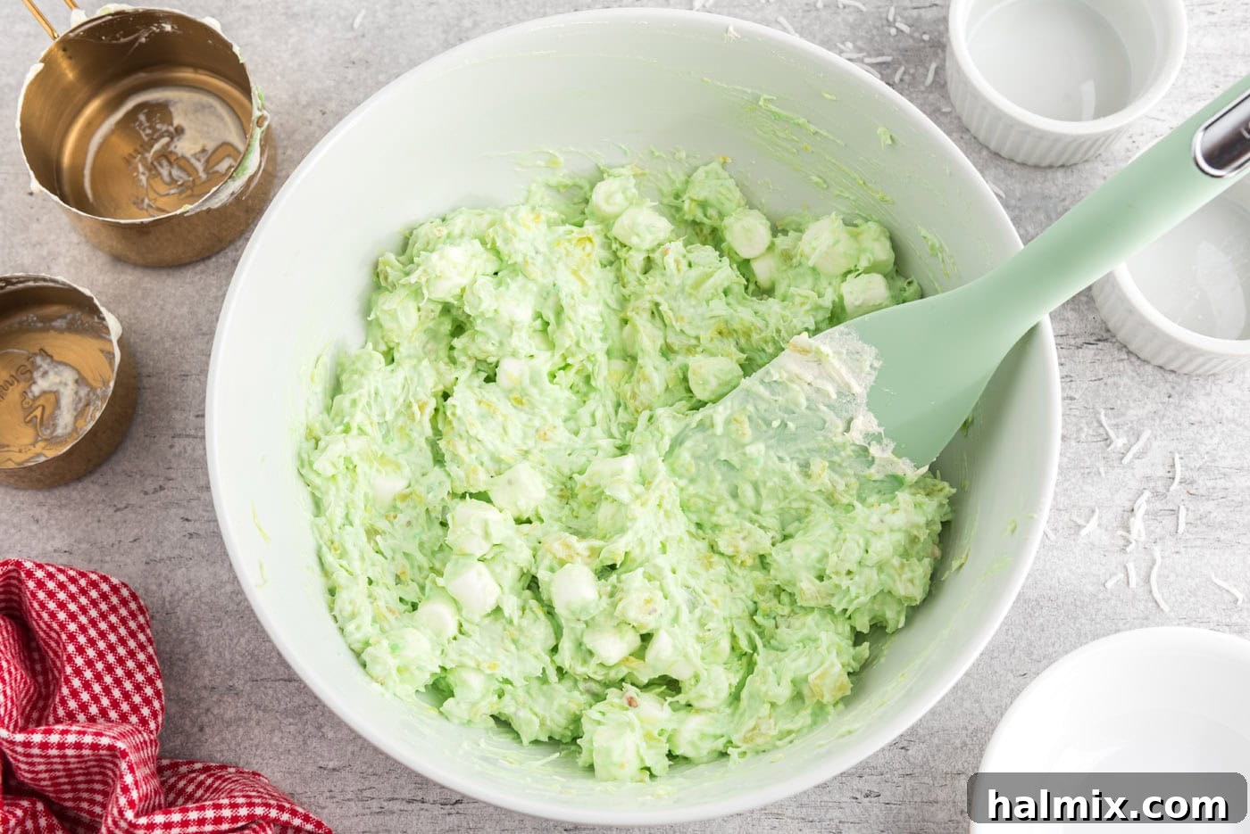 Emerald Cloud Dessert 8 watergate salad in a bowl with a rubber spatula