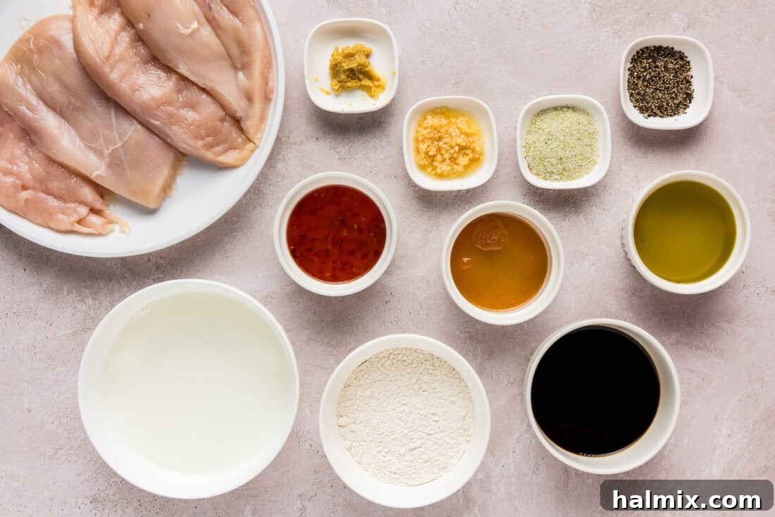 Tropical Coconut Chicken 4 A vibrant flat lay image showcasing all the ingredients for coconut chicken: chicken breasts, coconut milk, honey, sweet chili sauce, soy sauce, garlic, ginger, and flour.