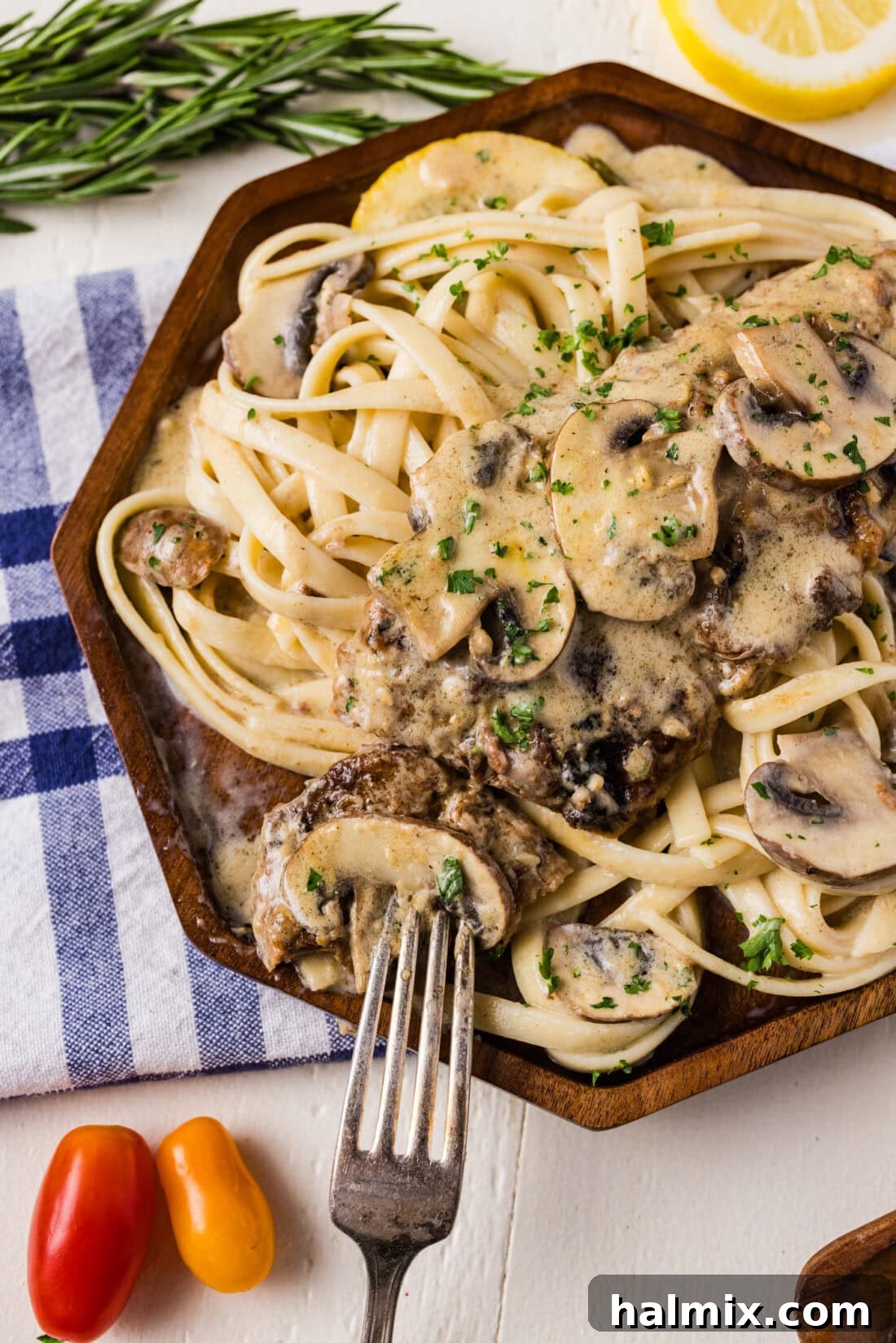 Close up photo of a plate of Veal Scallopini, showcasing tender veal in a rich mushroom and white wine sauce, garnished with fresh herbs.