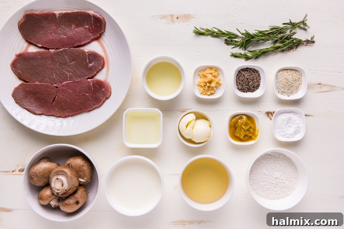 A selection of fresh ingredients laid out, including veal cutlets, mushrooms, lemon, fresh rosemary, and bottles of wine and cream, ready for making Veal Scallopini.