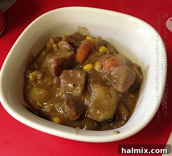 Beef stew with added chopped potatoes, carrots, and sliced mushrooms simmering