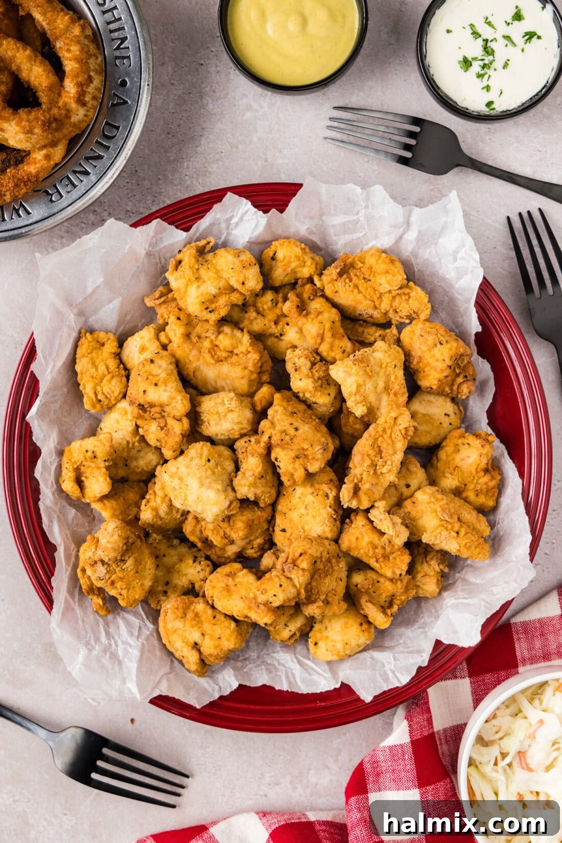 Popcorn Chicken on a parchment paper lined plate