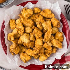Close up photo of Popcorn Chicken on a parchment paper lined plate