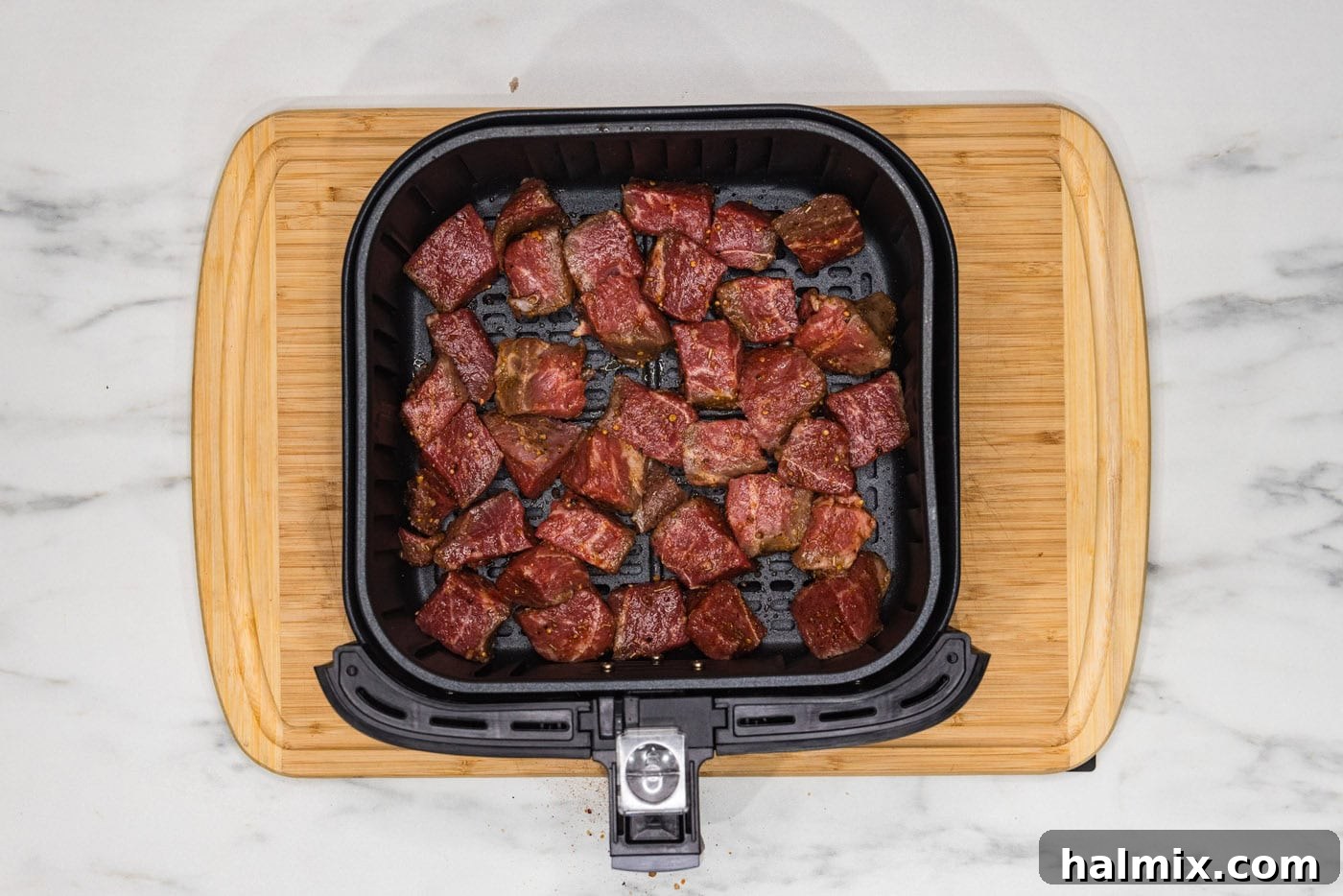 steak bites in an air fryer basket