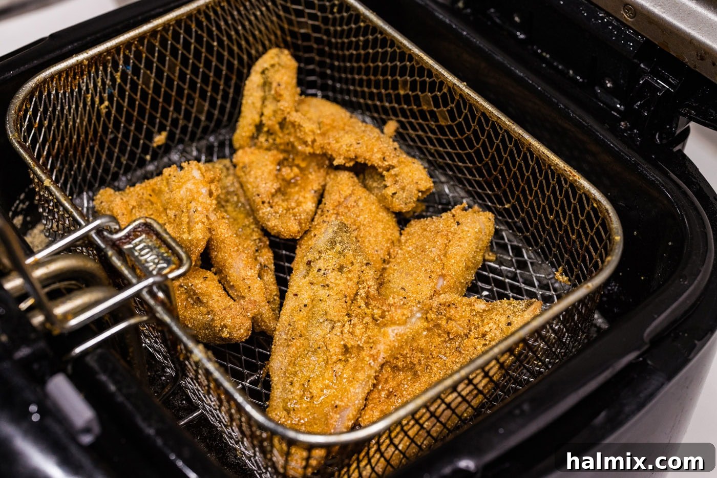 fried perch in a deep fryer basket