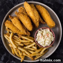 Fried Perch on a plate with fries and coleslaw