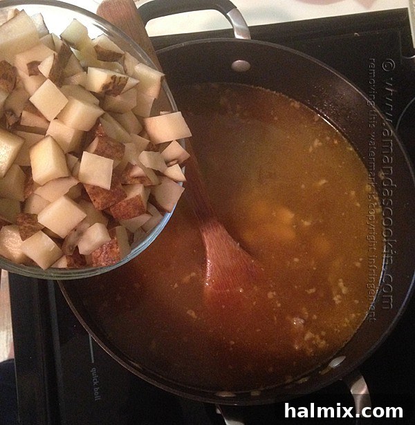 adding potatoes to soup