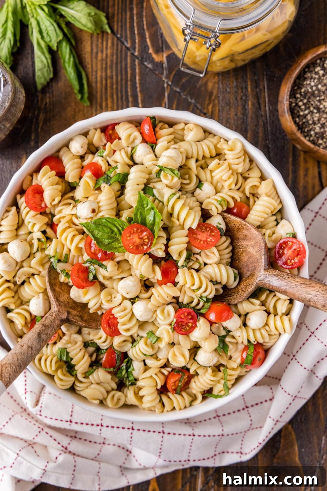 Close-up of a large bowl filled with colorful Caprese Pasta Salad, ready to be served