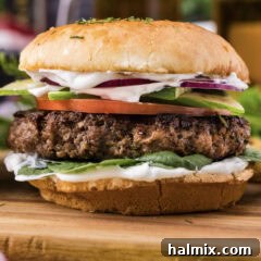 Close up photo of a Lamb Burger, showing toppings and bun