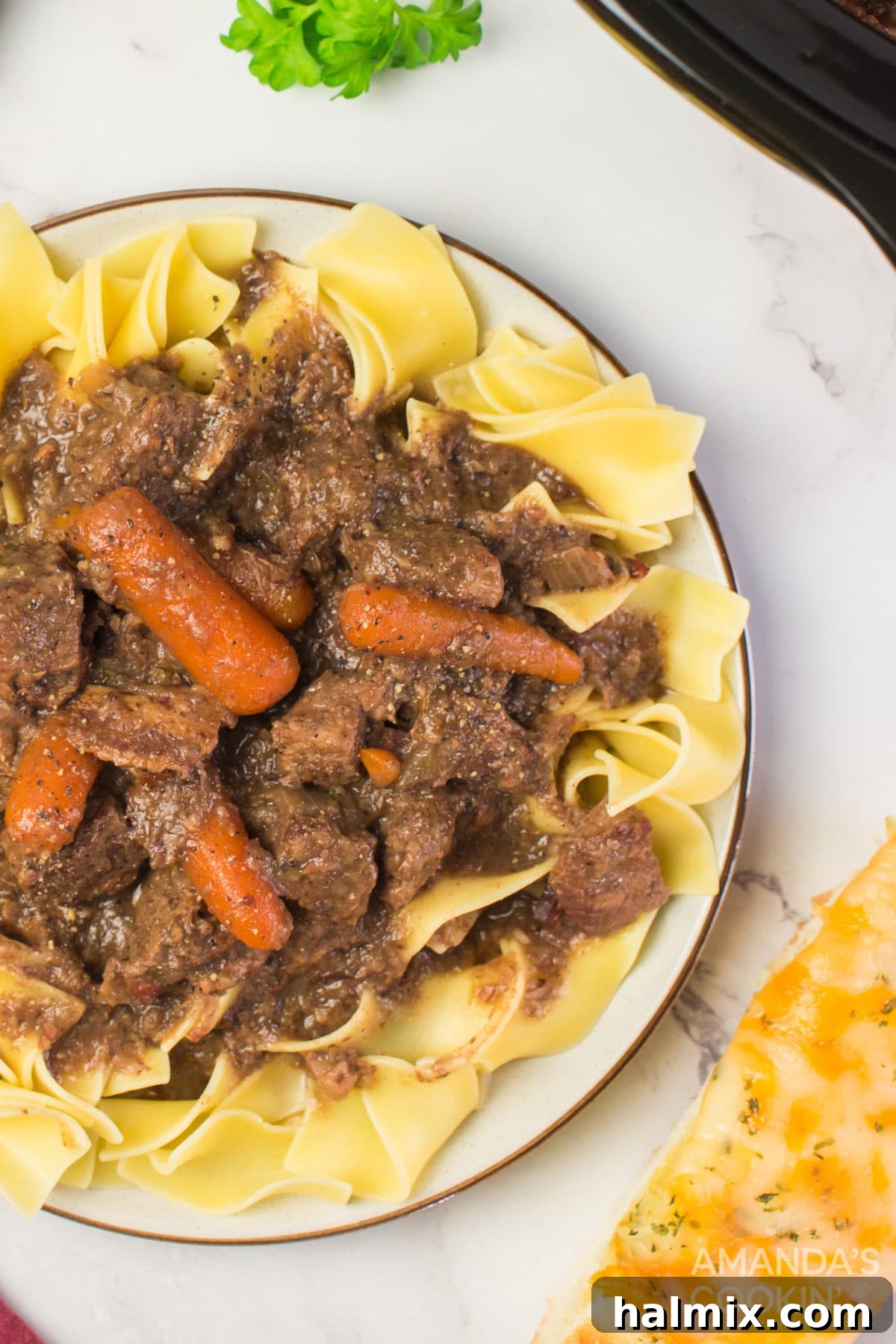 plate of beef burgundy on egg noodles