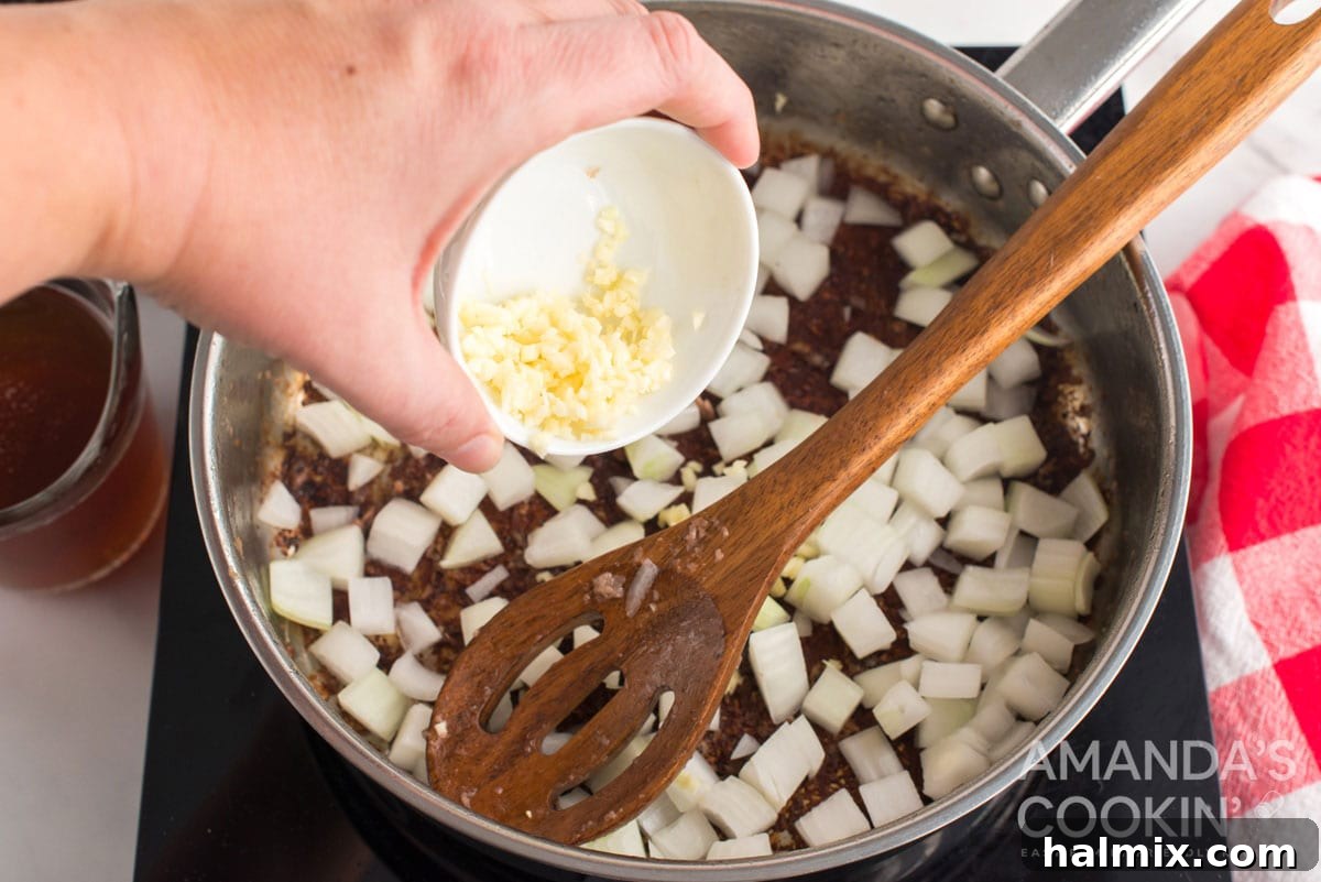 adding garlic to pan