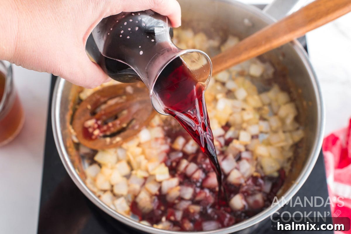 adding burgundy wine to pan