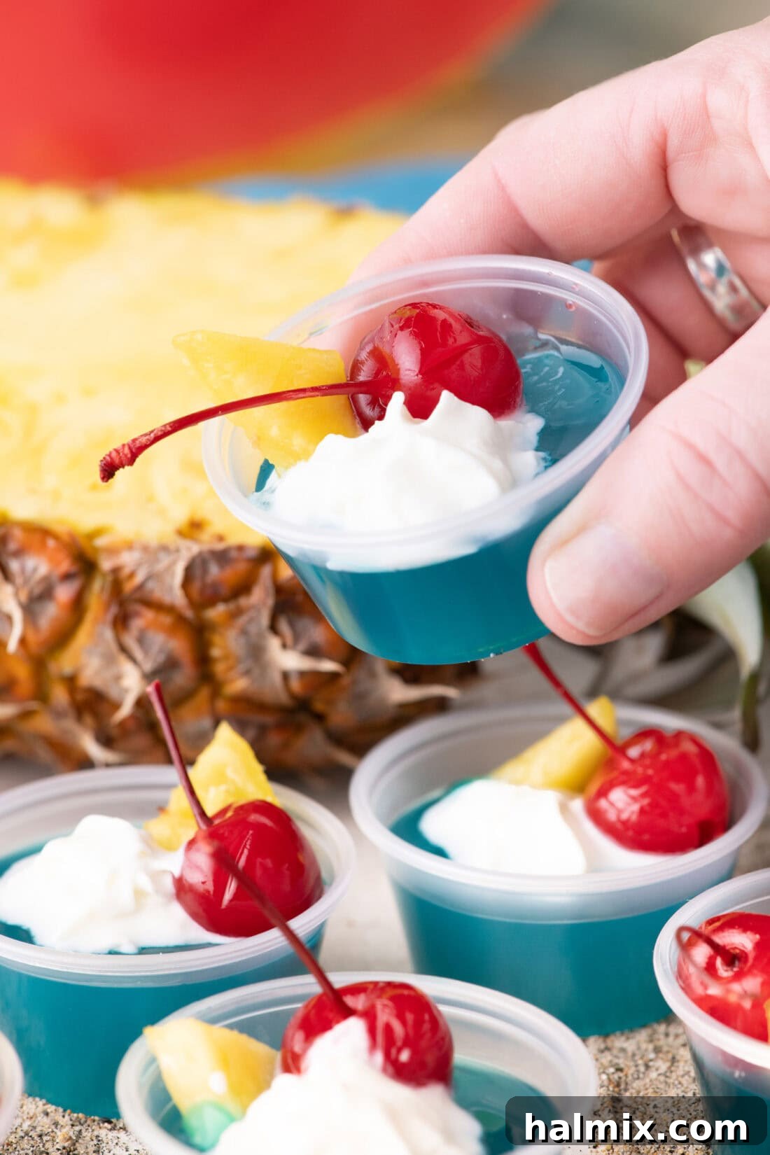 Hand holding up a Blue Hawaiian Jello Shot