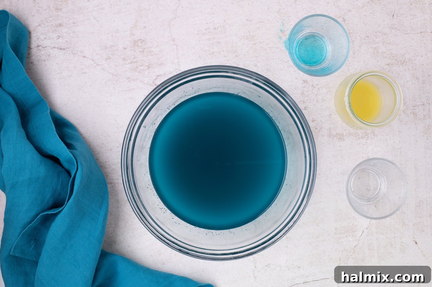 blue jello powder mixed with water in a bowl