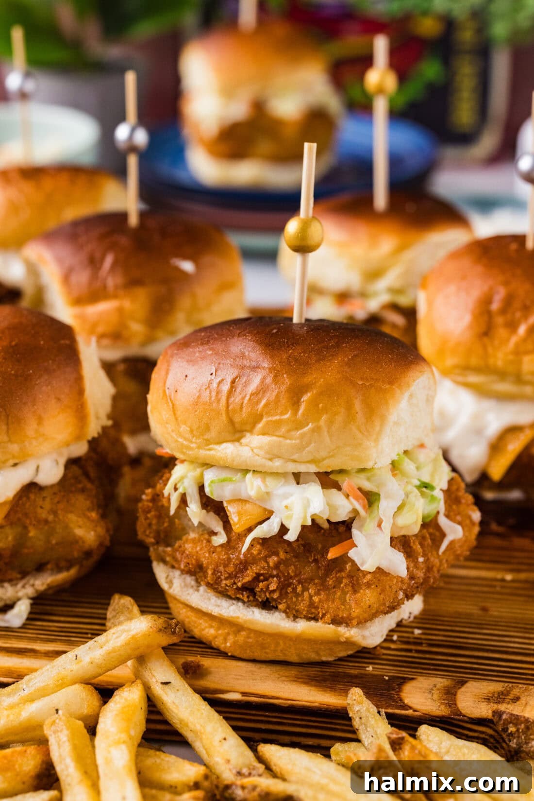 Close up photo of a Fish Slider on a wooden platter with french fries