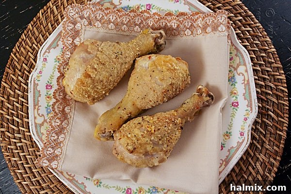 Crispy Baked Chicken Drumsticks 2 Crispy golden brown oven fried chicken legs resting on a wire rack.