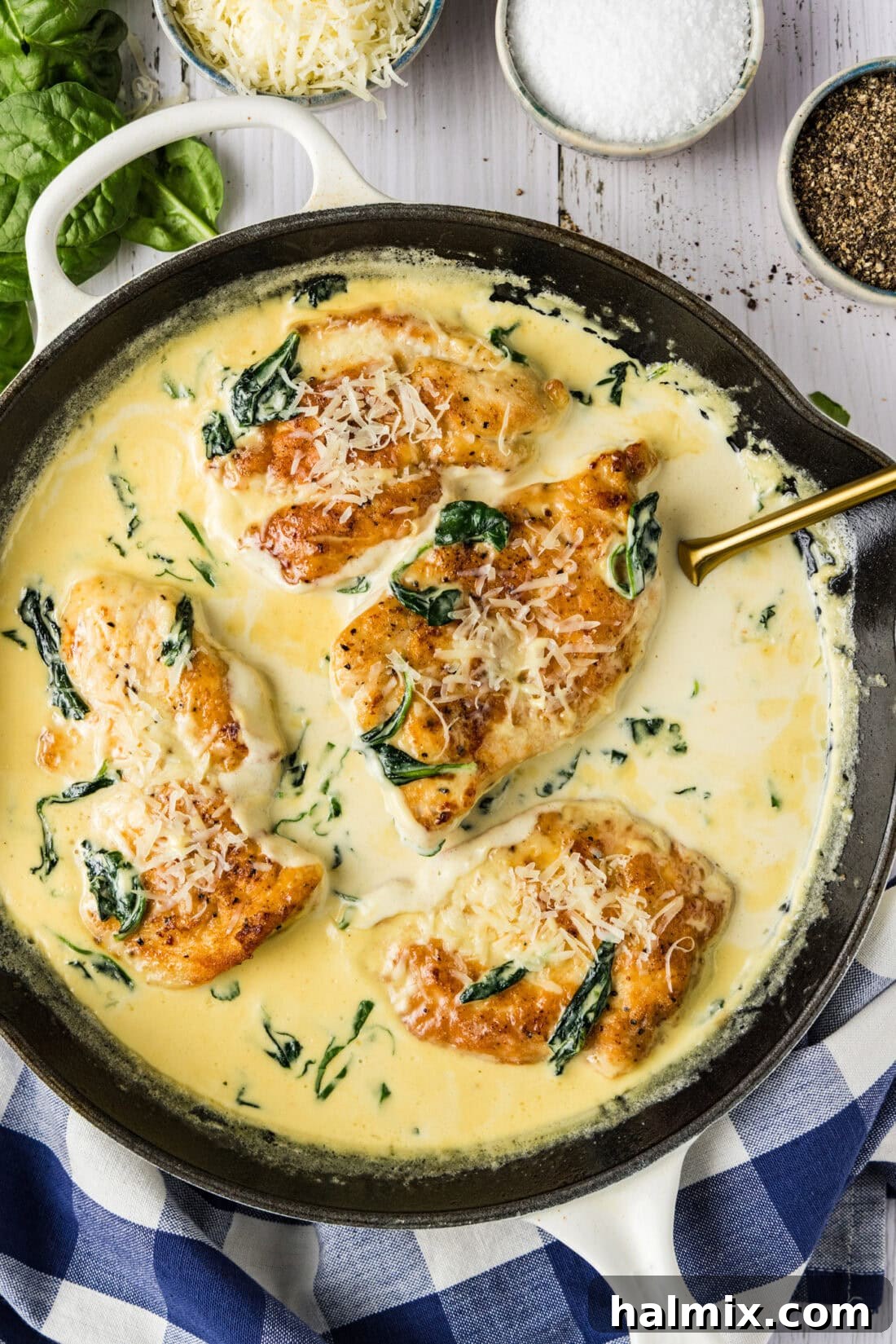 Skillet of Chicken Florentine with a serving spatula, ready to be dished out