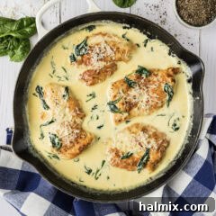 Close up photo of a skillet of Chicken Florentine, showcasing the creamy sauce and chicken