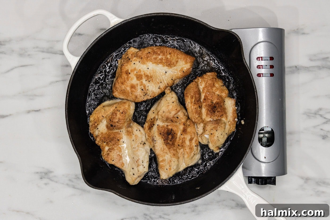 golden chicken cutlets perfectly seared in a cast iron skillet