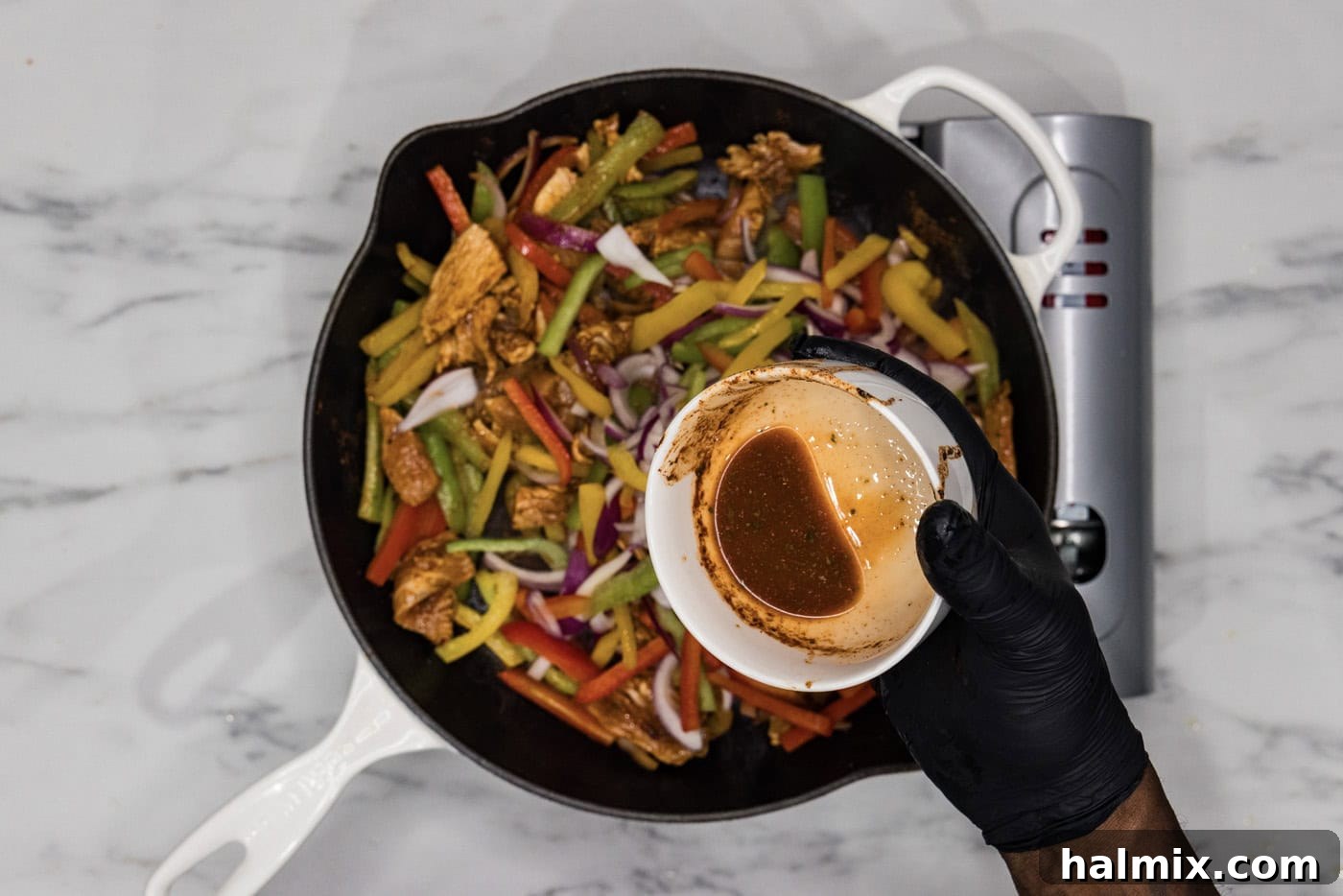 Sizzling Chicken Fajitas 7 Pouring remaining marinade into skillet with chicken fajitas