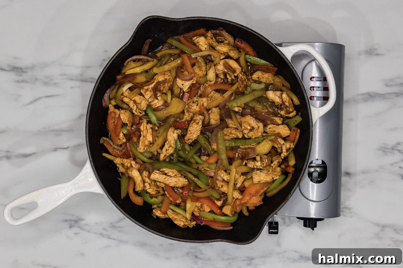 Sizzling Chicken Fajitas 8 Chicken fajitas simmering in a cast iron skillet, covered