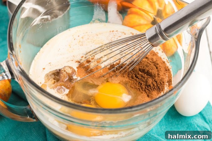 ingredients for pumpkin batter in a bowl, ready to be mixed