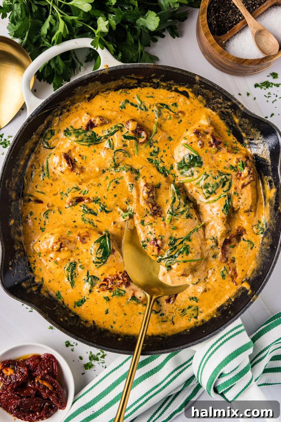 Creamy Sun-Dried Tomato Tuscan Chicken 2 Skillet of Tuscan Chicken with a spatula in it