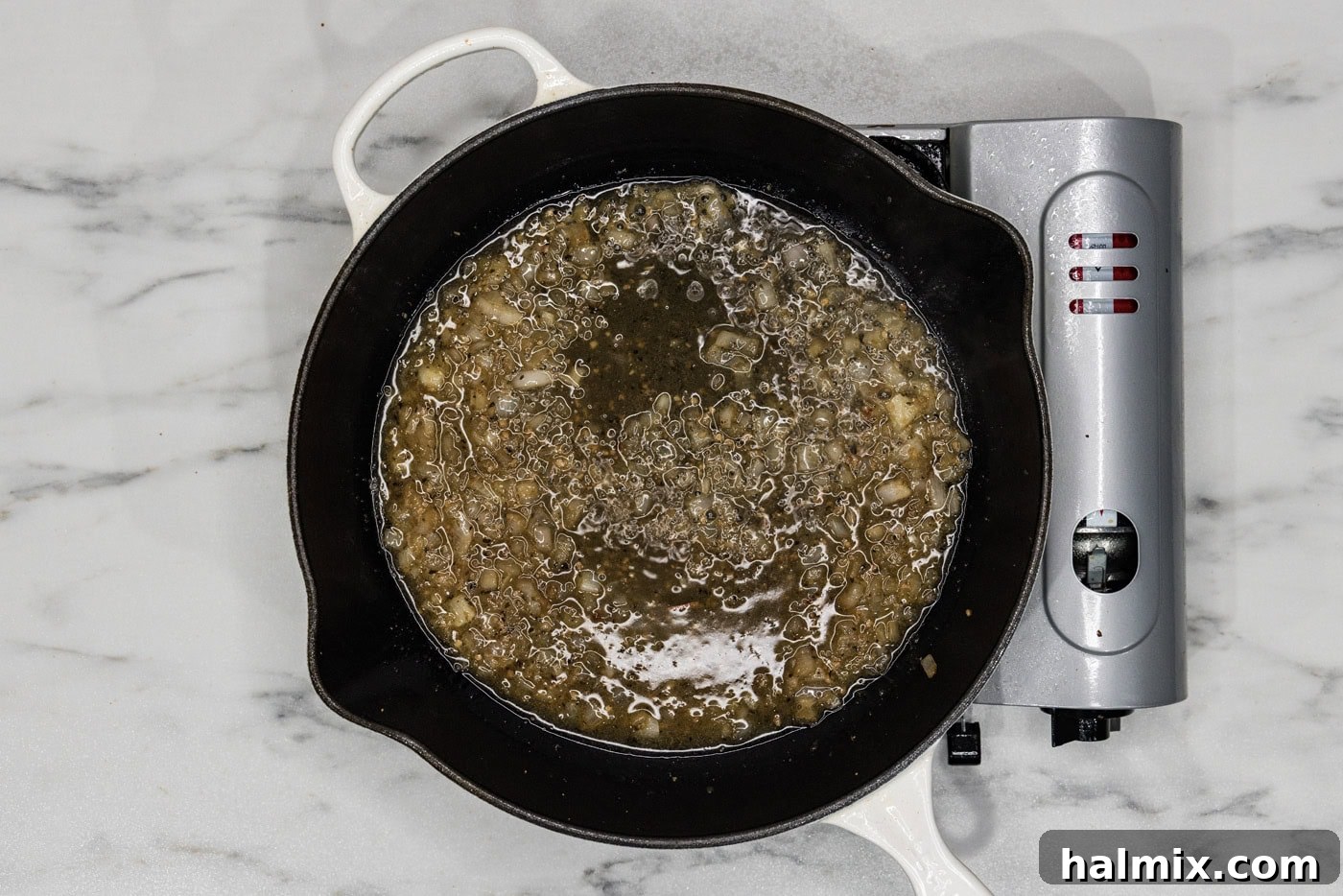 Creamy Sun-Dried Tomato Tuscan Chicken 8 shallots and garlic mixture in a skillet with white wine