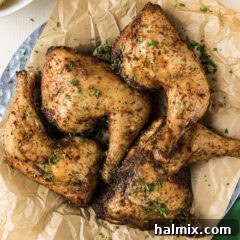 Close up photo of Smoked Chicken Quarters on a parchment lined platter