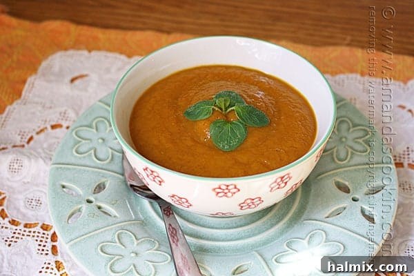 A close-up photo of a bowl of creamy pumpkin soup, elegantly garnished with a delicate swirl of cream and vibrant fresh parsley, with a gleaming spoon resting gracefully on the side.