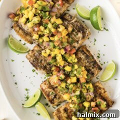 Grilled Mahi Mahi on a white platter with lime wedges